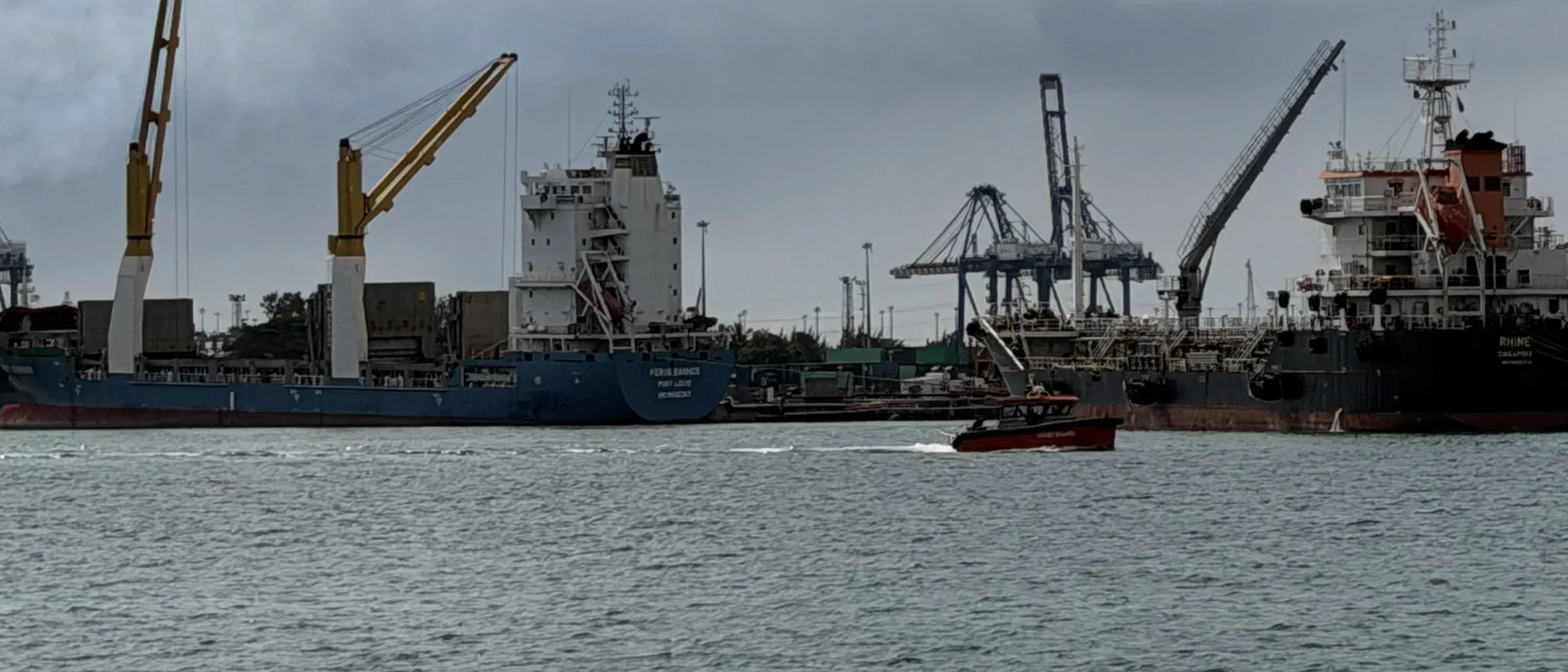 Cargo vessels and cranes at the port of Toamasina, Madagascar.